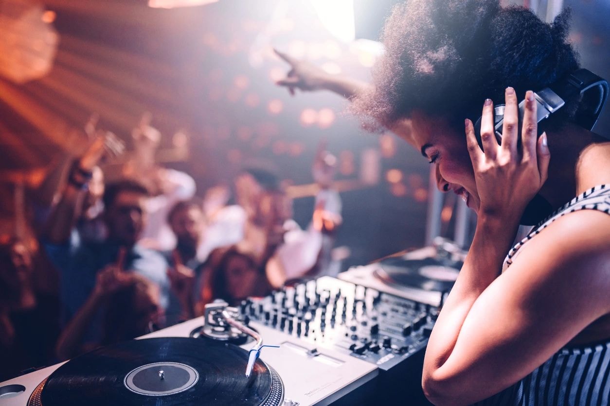 DJ performing at a crowded nightclub party