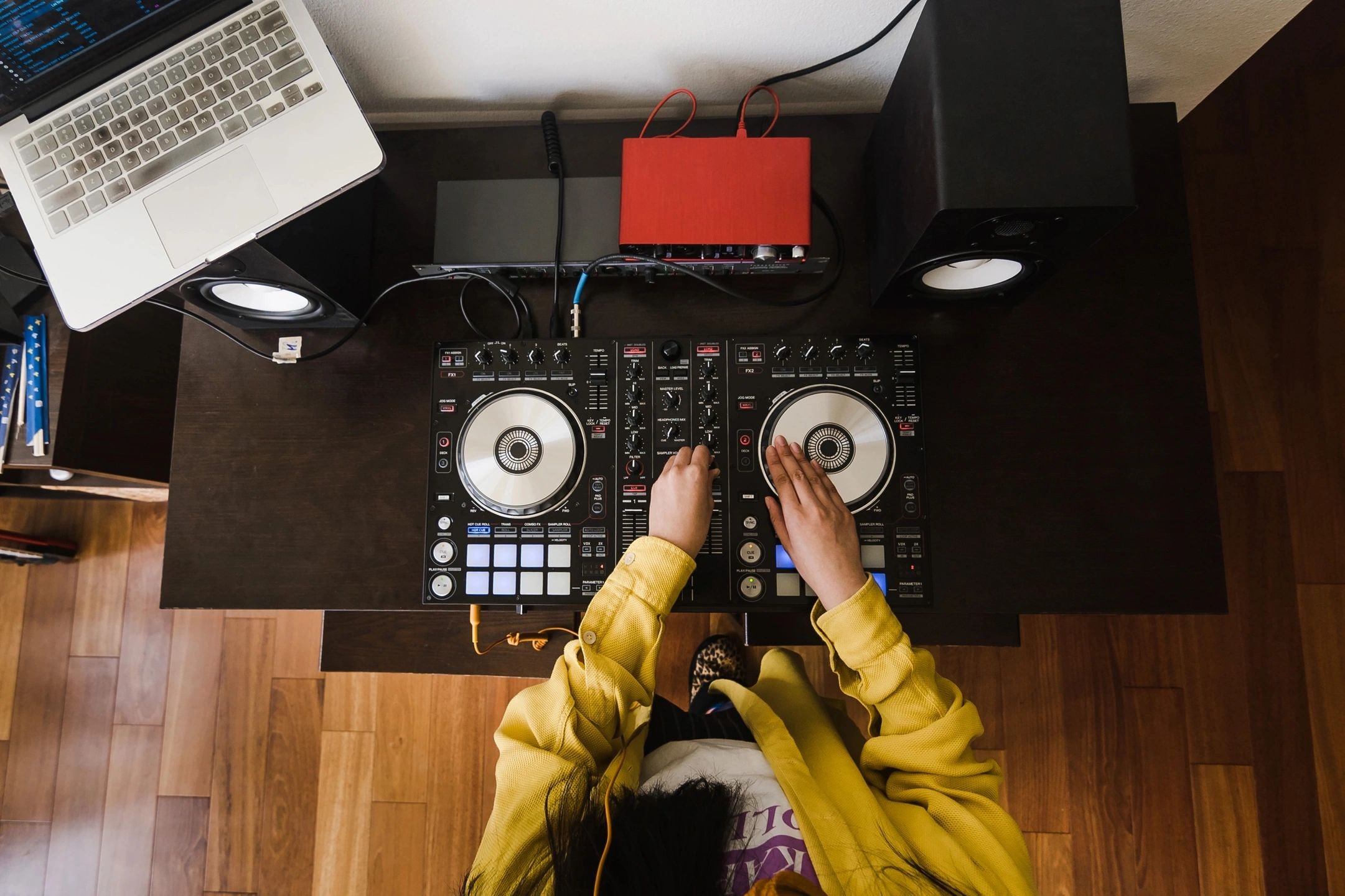 DJ mixing music on turntables overhead view